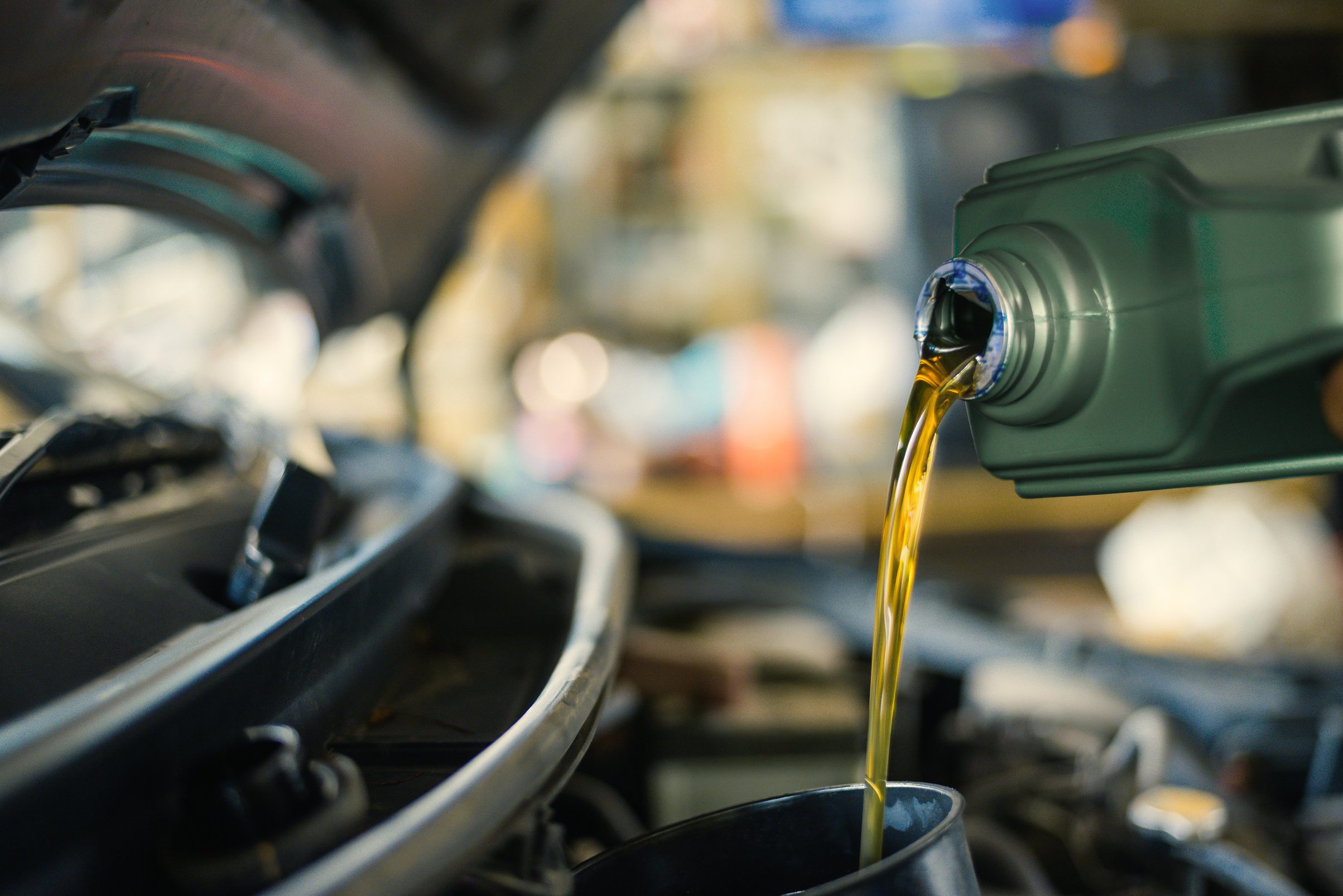 Lubricate your car engine with oil, Motor oil pouring to car engine.